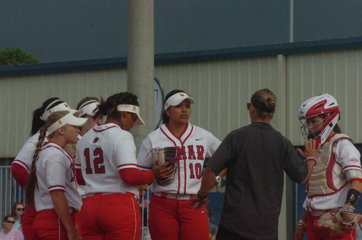 Lamar softball coach Holly Bruder gives instruction during the first inning of the Lady Cardinals' game against McNeese State on Saturday at Cowgirl Field in Lake Charles.