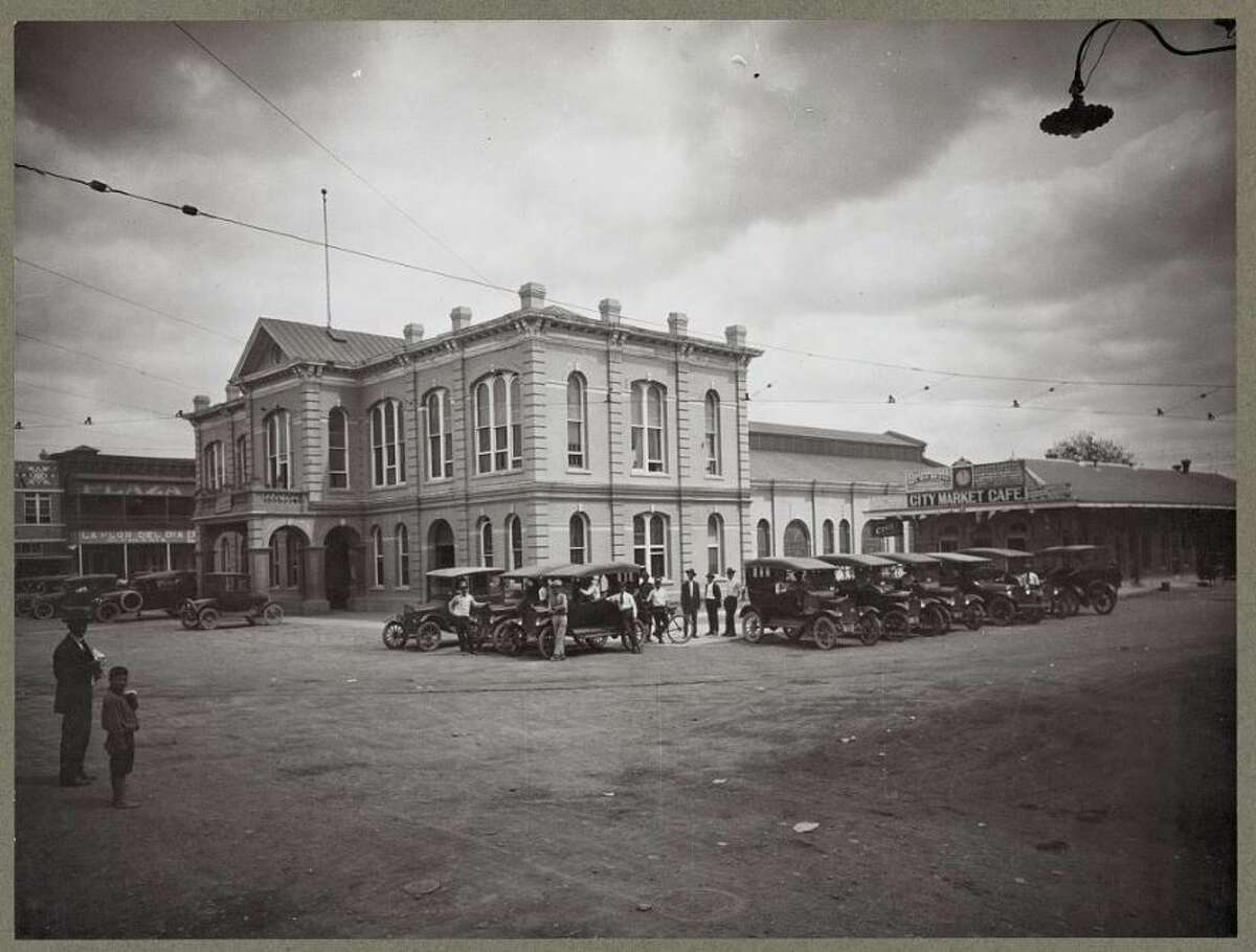 The '20s:  A City market with cars parked on the square in downtown Laredo.