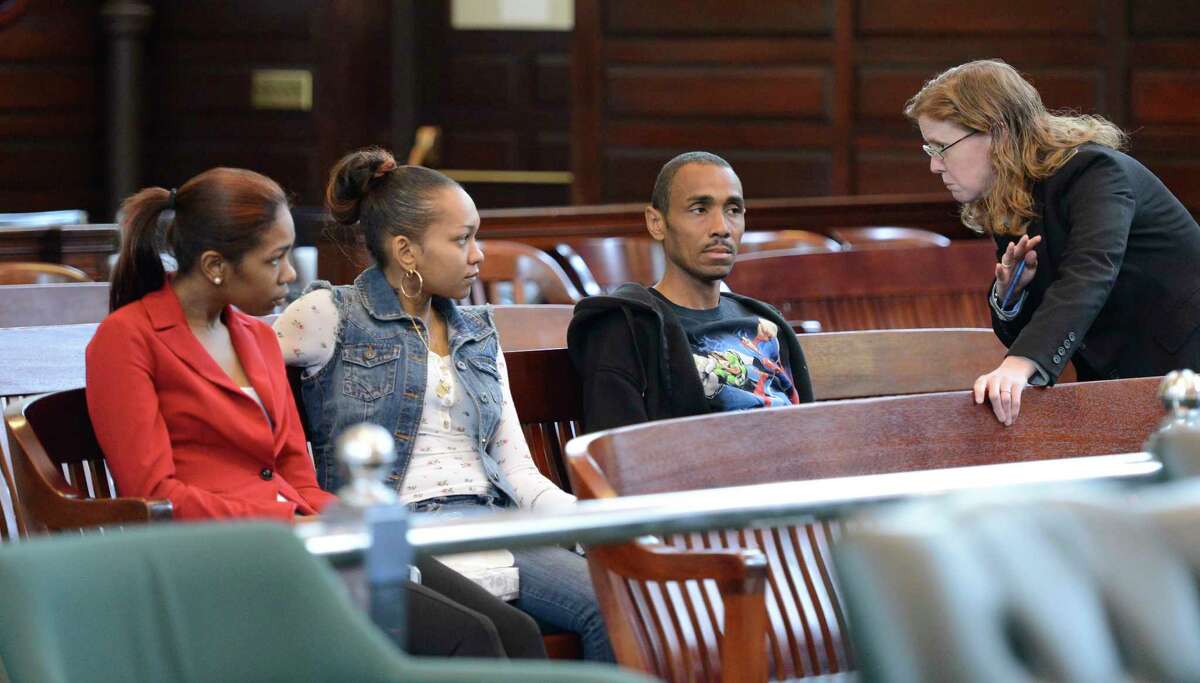Assistant District Attorney Elizabeth Kennedy, right, discusses the murder case of Takim Smith with his father Leyward Morese, second from right, as Smith's sister Taleena Morse, left, and Jaminla Michaud, second from left, listen, May 13, 2013, in the Rensselear County Courthouse in Troy, N.Y. (Skip Dickstein/Times Union)