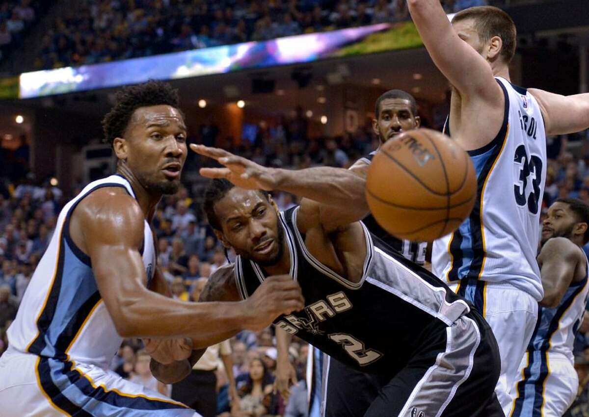 San Antonio Spurs forward Kawhi Leonard (2) loses control of the ball while defended by Memphis Grizzlies guard Wayne Selden Jr., left, and center Marc Gasol (33) during the second half of Game 4 in an NBA basketball first-round playoff series Saturday, April 22, 2017, in Memphis, Tenn.