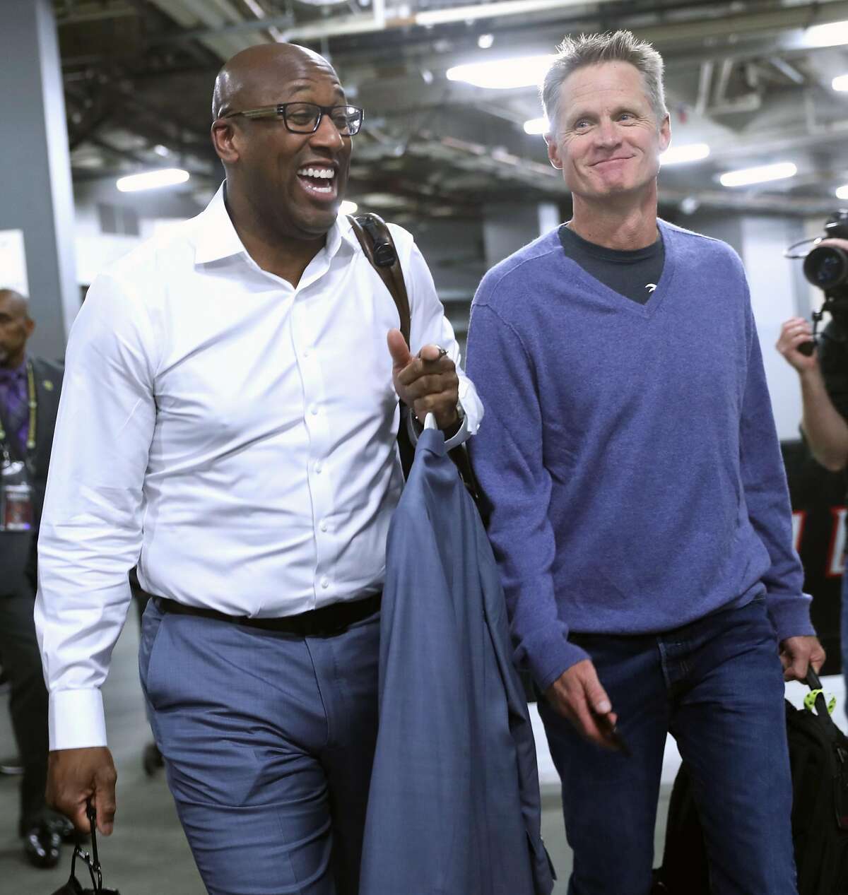 Golden State Warriors' interim head coach Mike Brown and head coach Steve Kerr arrive before playing Portland Trail Blazers in Game 4 of NBA Western Conference 1st Round Playoffs at Moda Center in Portland, Oregon on Monday, April 24, 2017.