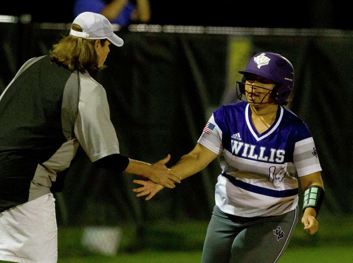 Kalynn Johnson #14 of Willis gets a high-five from head coach Stephanie Shelly after hitting a three-runer homer off Huntsville starting pitcher Sydney Paul during the fourth inning of a District 20-5A high school softball game Tuesday, April 4, 2017, in Willis. Willis run-ruled Huntsville 14-4 in five innings.