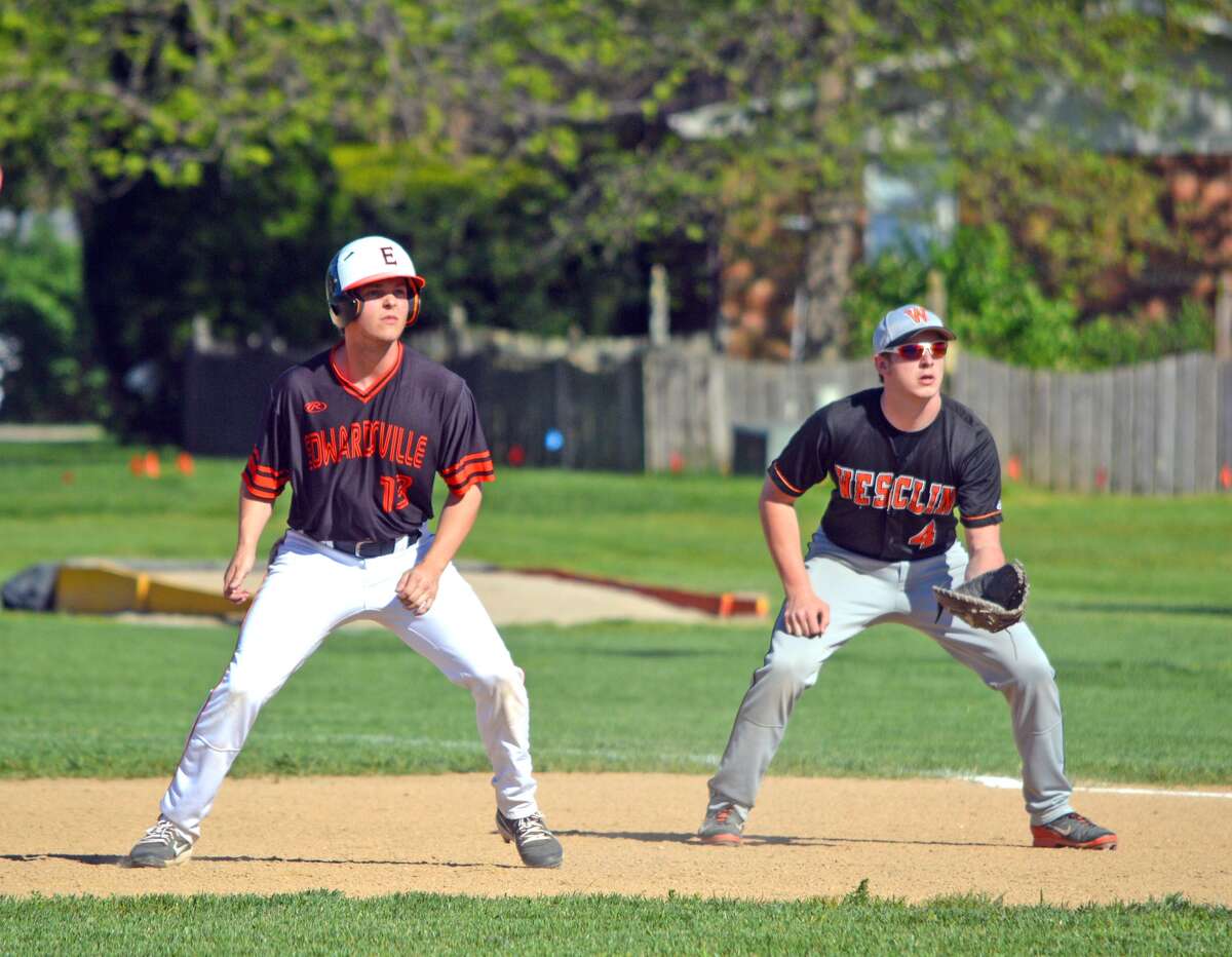 Edwardsville senior Joel Quirin, left, leads off first base during the fifth inning of Monday’s game at Trenton Wesclin.