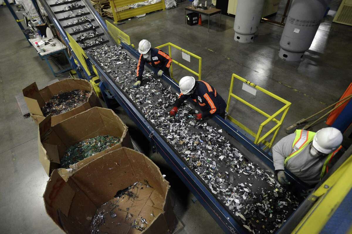Employees sort through material from recycled electronics at a Sims Recycling facility in Roseville, California. Austin-based Urban Mining Company is proposing to bring a similar facility that will focus on recycling rare earth metal magnets to San Marcos.