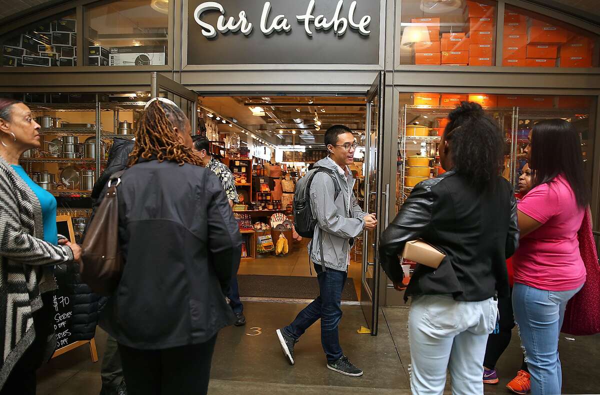 InstaCart operations manager Carson Lee (middle) greets InstaCart shoppers about to be trained in shopping at Sur la table, a non-grocery store specializing in kitchen supply on Monday, April 24, 2017, in San Francisco, Calif.