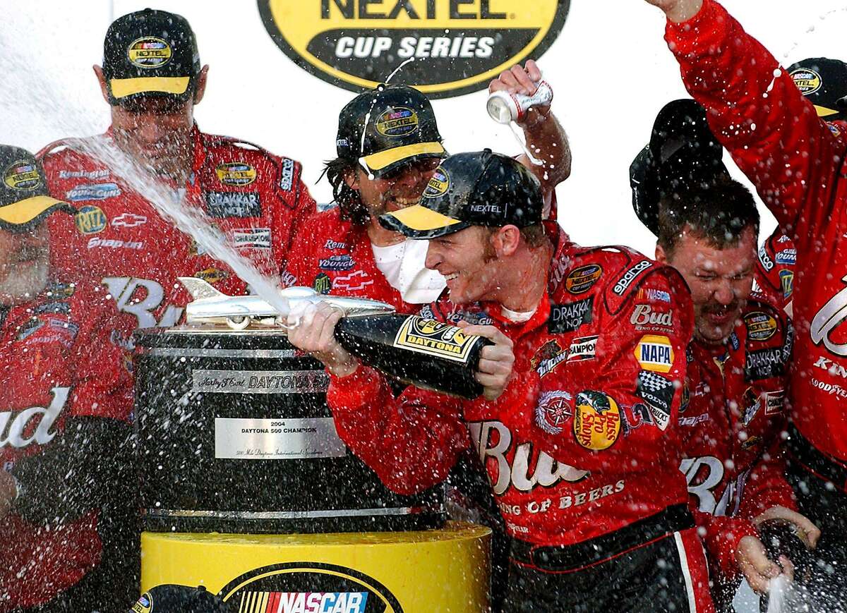 Dale Earnhardt Jr. sprays champagne on members of his crew after winning the Daytona 500 at Daytona International Speedway on Feb. 15, 2004, in Daytona Beach, Fla.
