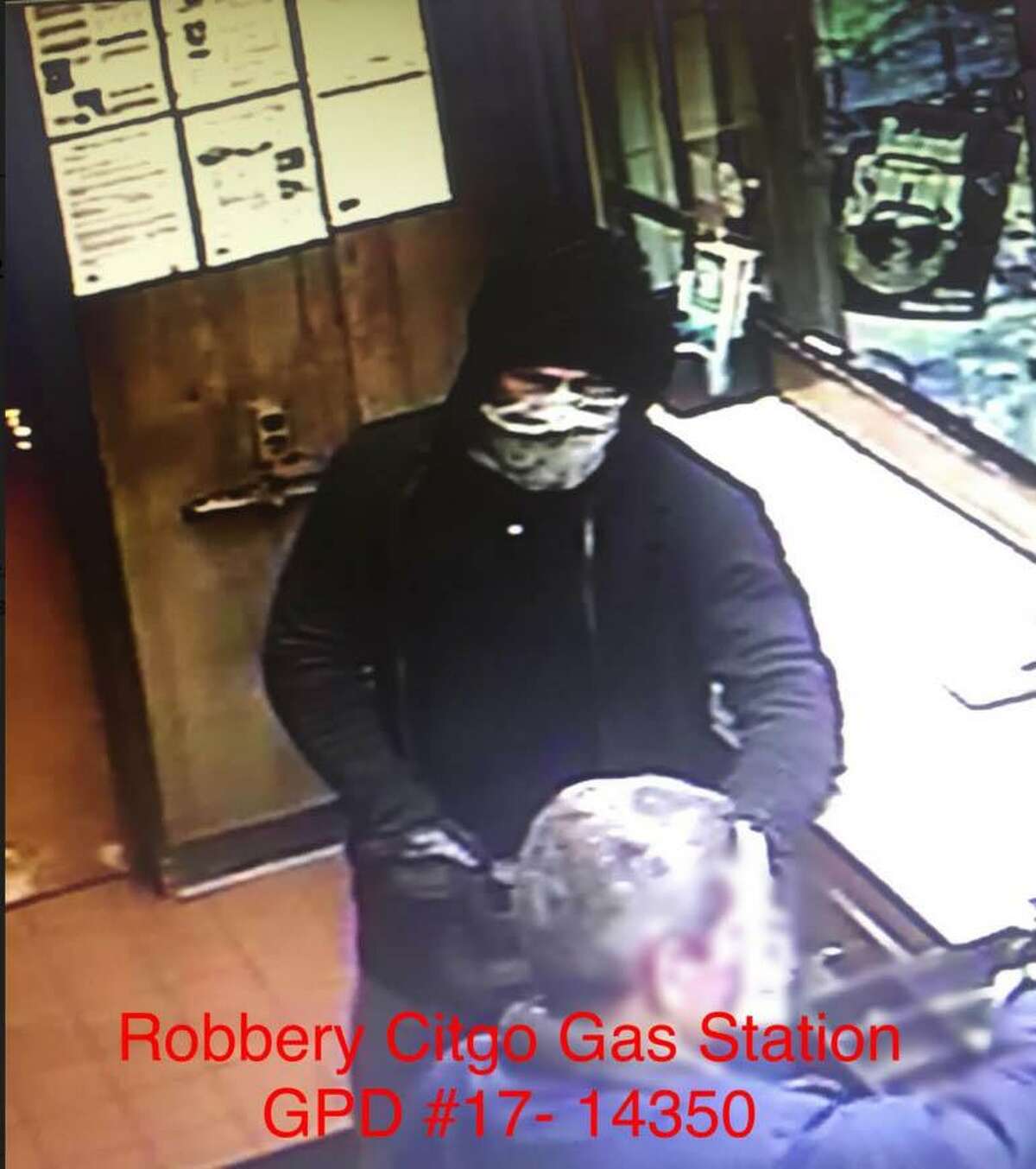 The suspect wanted in a gas-station robbery in Cos Cob Monday night was armed with a handgun.