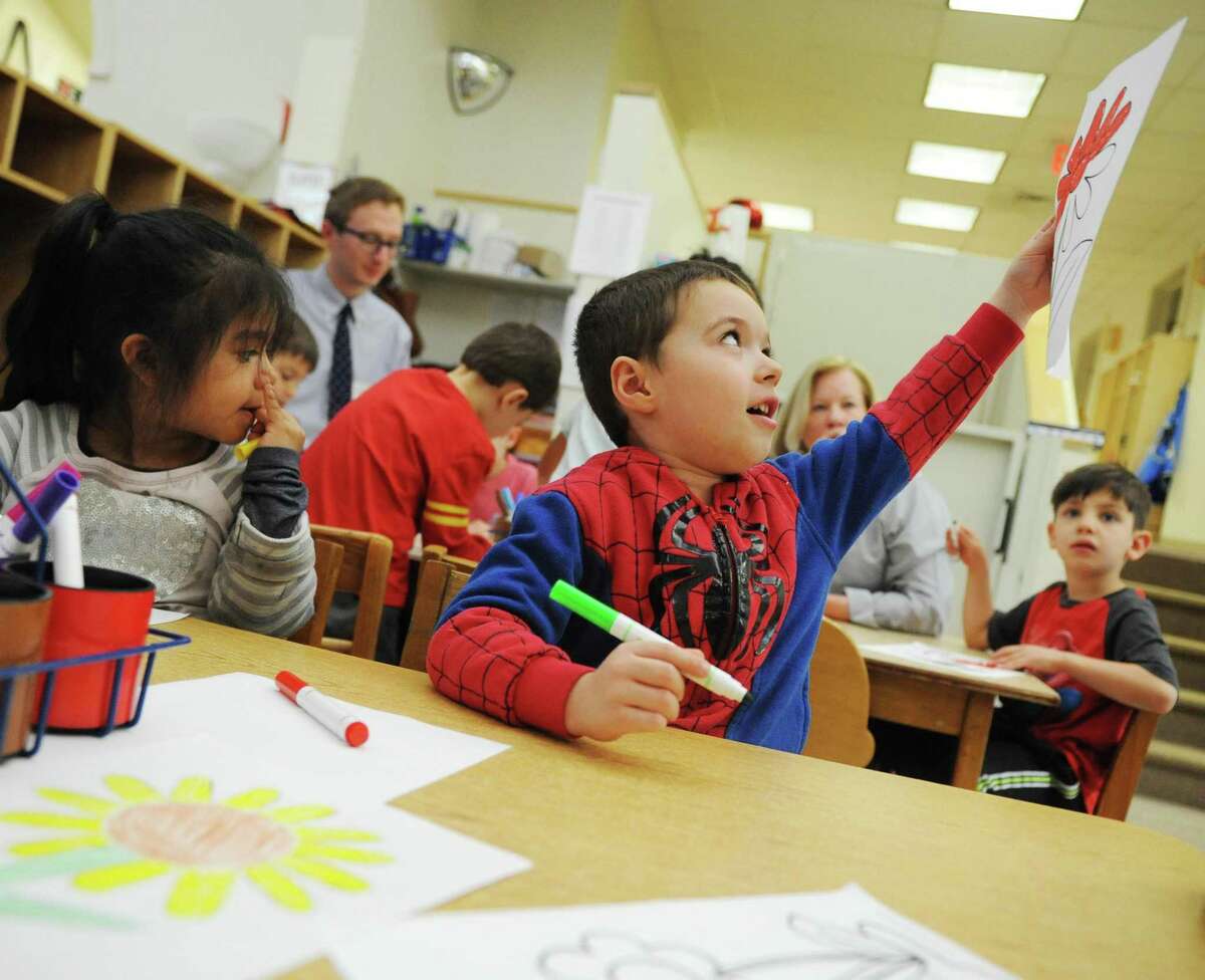 Preschooler Alexander Richardson enthusiastically shows his flower drawing while working on an activity for Week of the Child at Family Centers' Gateway Preschool in Greenwich, Conn. Tuesday, April 25, 2017. Family Centers held many different activities for Week of the Child, including the flower project, a smoothie-making activity and a music project.