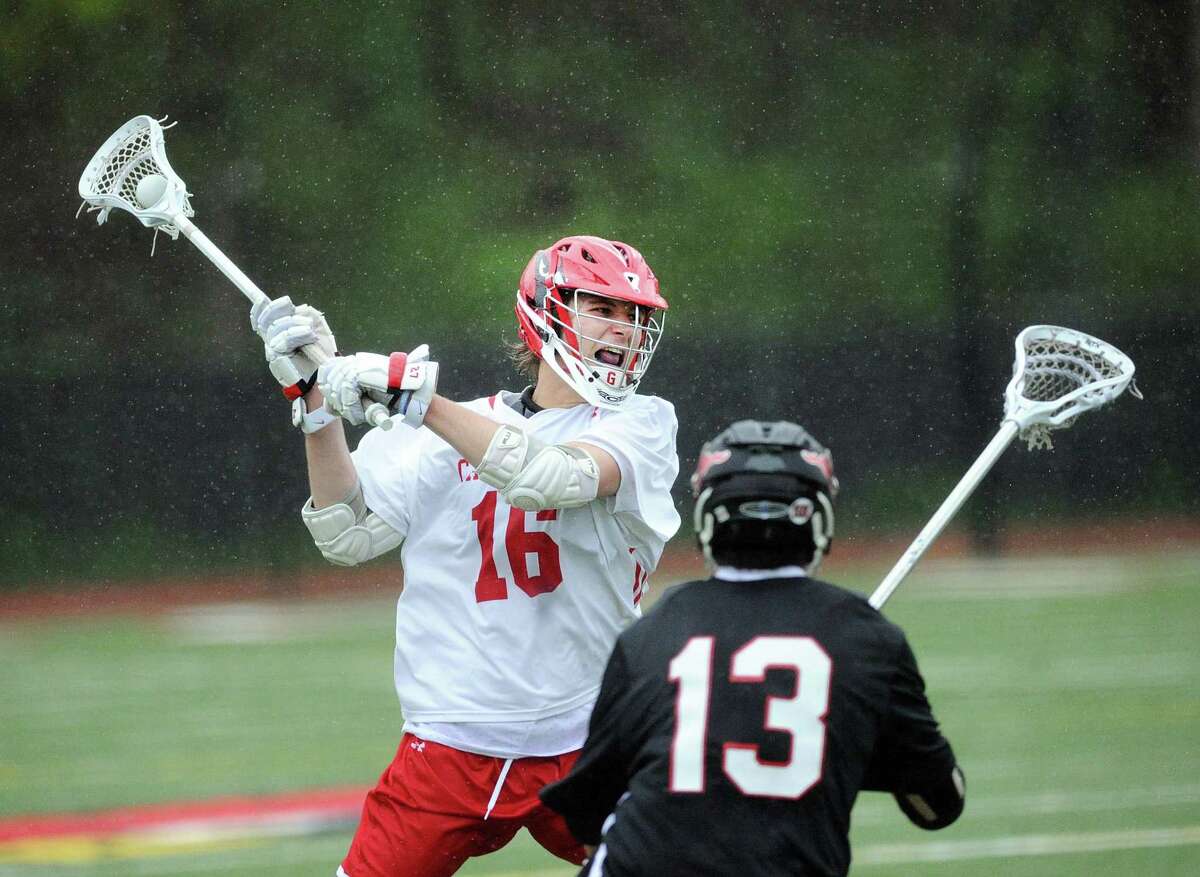 At left, Zach Tucker of Greenwich prepares to unlease a shot on goal as Chris Montenegro (13) of Fairfield Warde defends during the boys high school lacrosse match between Greenwich High School and Fairfield Warde High School at Greenwich, Conn., Tuesday, April 25, 2017.