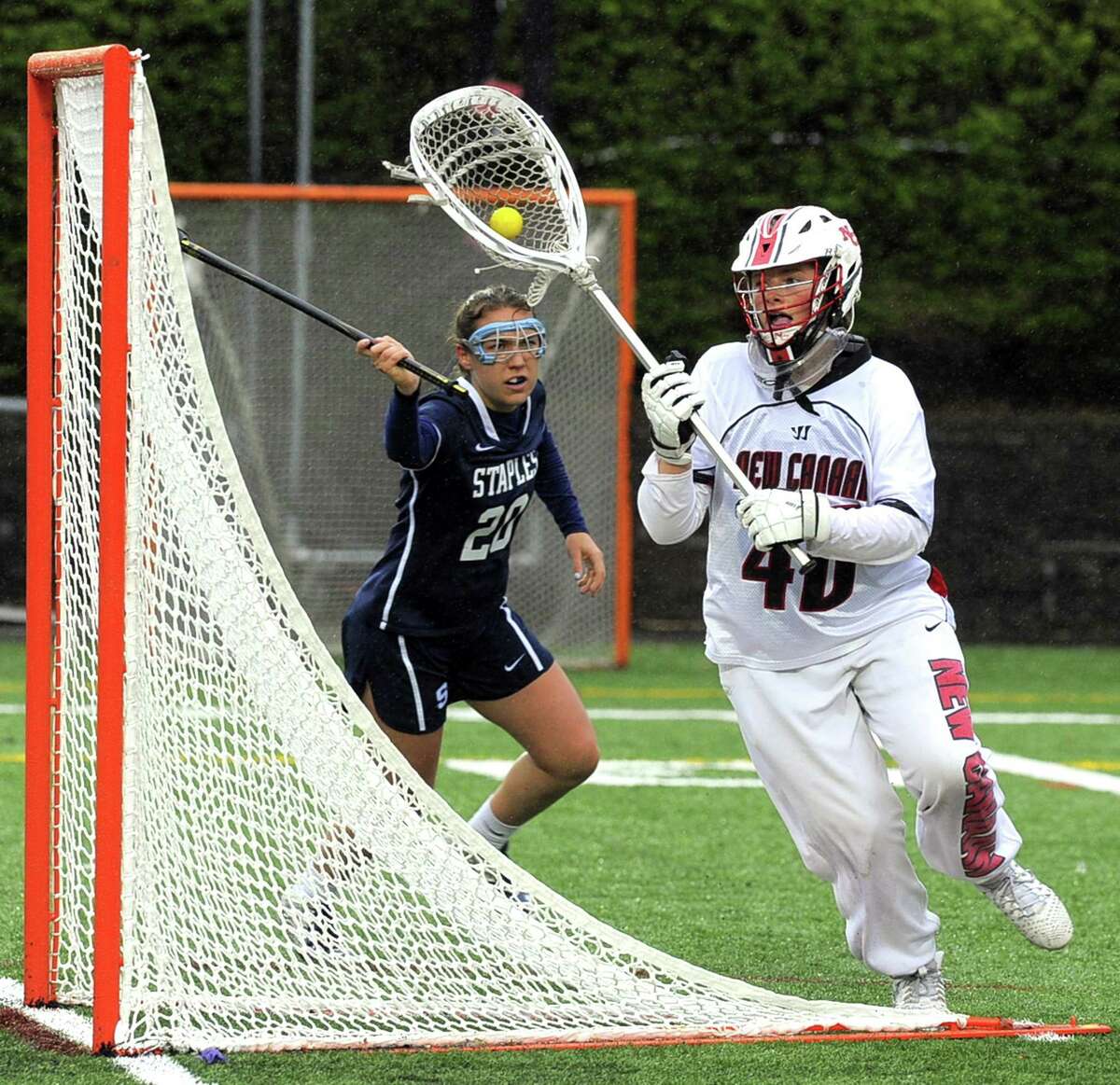New Canaan goalie Caroline O'Dea looks to pass forward following a save against Staples in a varsity girls lacrosse game at New Canaan High School Dunning Field on Tuesday, April 25, 2017. New Canaan defeated Staples 16-8.