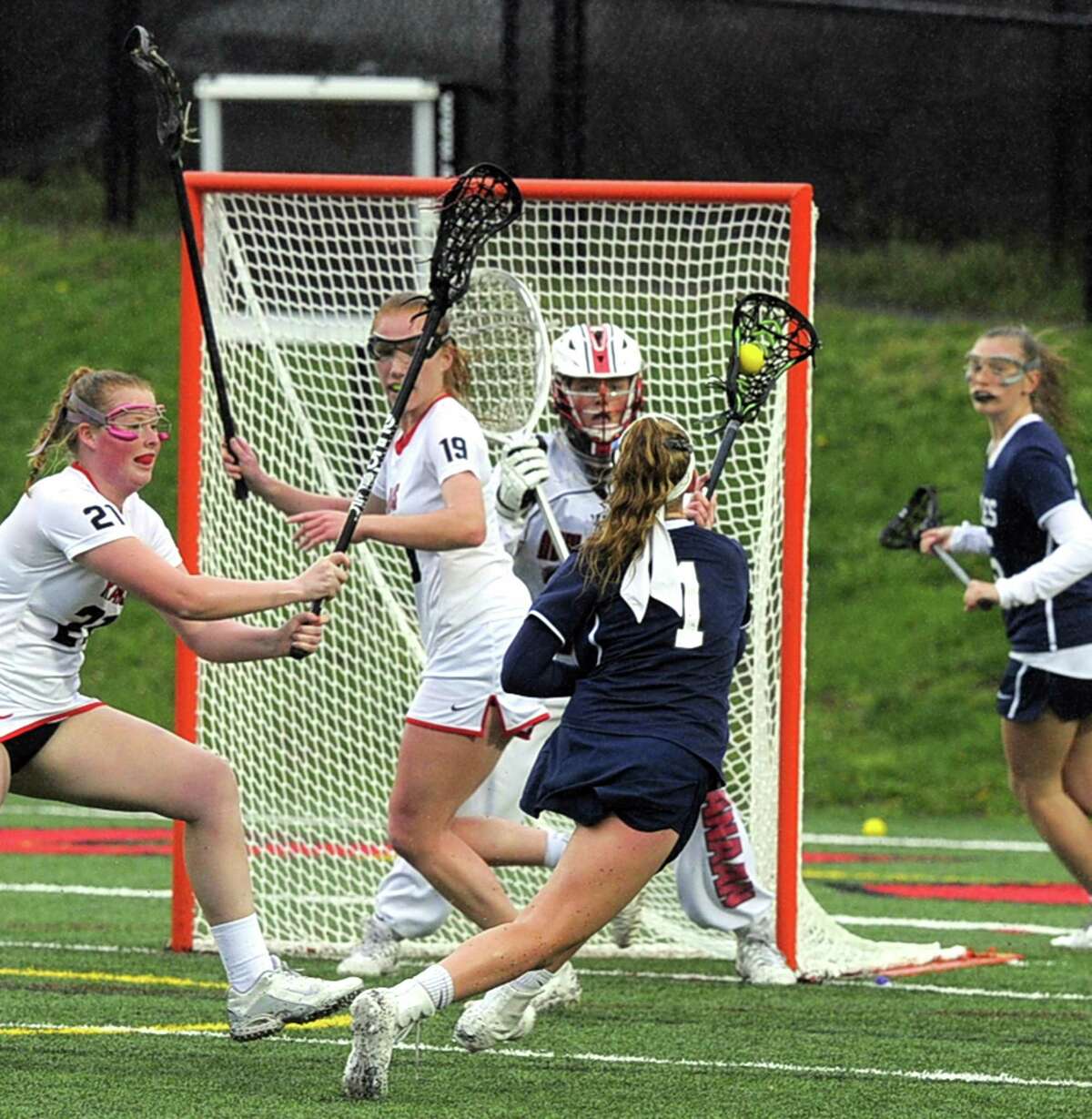 Staples Ellen Fair fires a shot on New Canaan goalie Caroline O'Dea in a varsity girls lacrosse game at New Canaan High School Dunning Field on Tuesday, April 25, 2017. New Canaan defeated Staples 16-8.