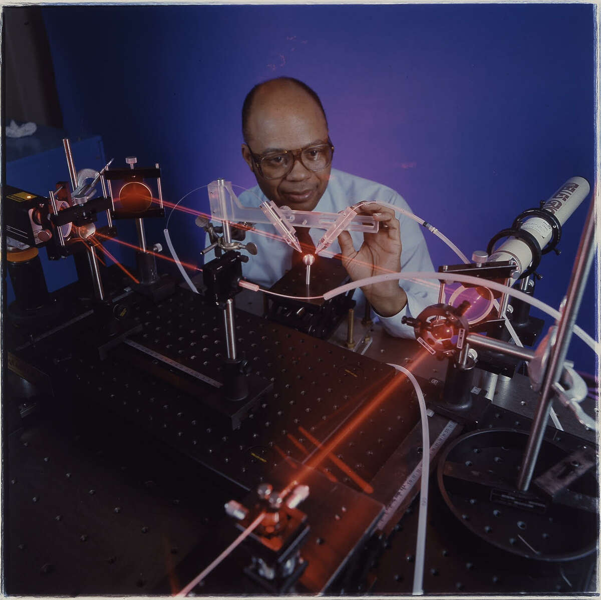 Marshall Jones, who holds 55 U.S. patents and is being inducted into the National Inventors Hall of Fame, poses with an industrial laser he used to make innovative breakthroughs in manufacturing. (Photo courtesy of General Electric)