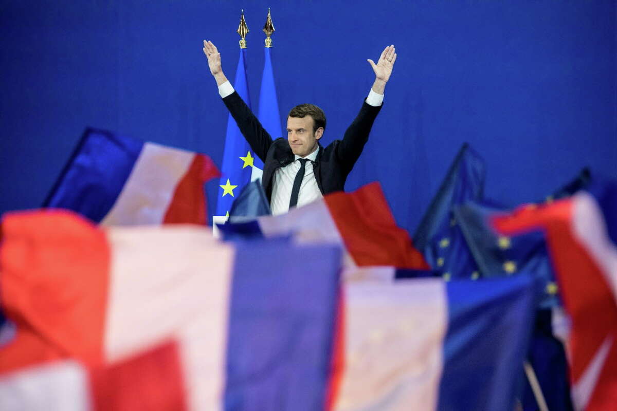 Emmanuel Macron, France's independent presidential candidate, waves while speaking to supporters after the first round of the French presidential election in Paris on April 23, 2017. MUST CREDIT: Bloomberg photo by Christophe Morin.