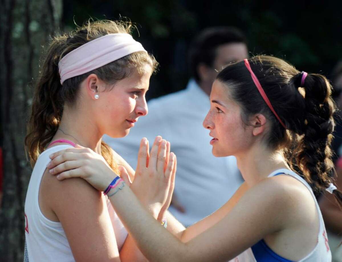 Greenwich High School doubles teammates, Katey Hopper, left and Lauren Daccache, right, console each other after losing the deciding in the State Class L Girls Tennis Championship against Fairfield Warde at Yale University, Friday, June 4, 2010.