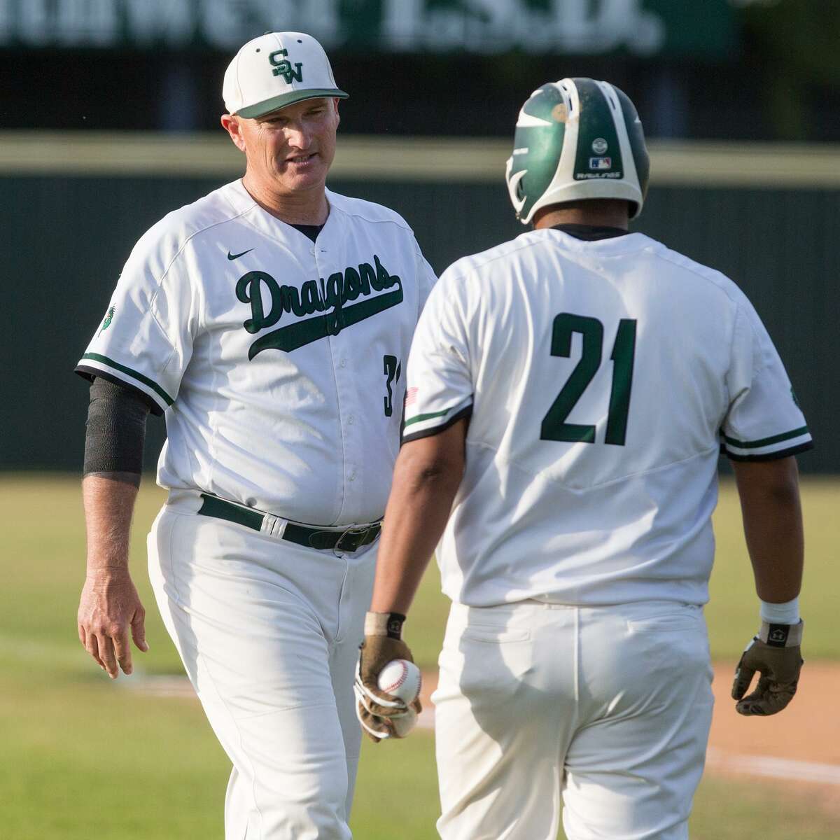 Southwest coach Bobby Behnsch (left) talks to Luis Padilla during a District 29-6A baseball game against South San on April 25, 2017.