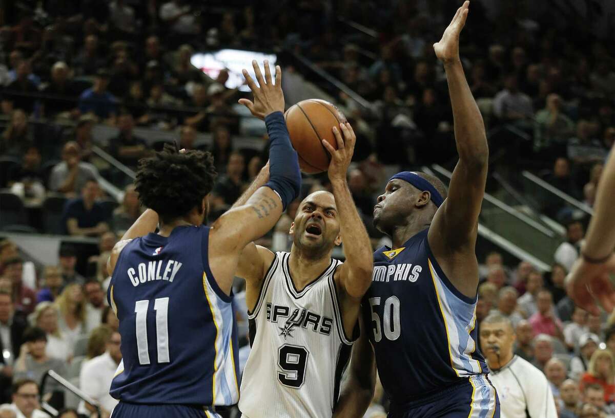 Spurs’ Tony Parker attempts to drive between theMemphis Grizzlies’ Mike Conley (11) and Zach Randolph (50) during Game 5 of the Western Conference playoffs at the AT&T Center on April 25, 2017.