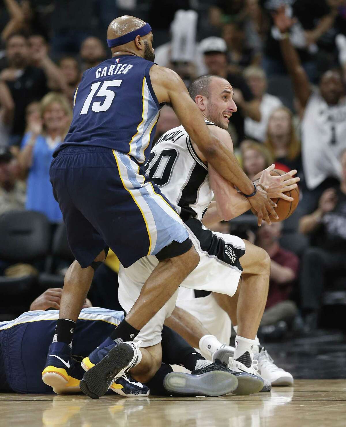 Spurs' Manu Ginobili (20) gets fouled by Memphis Grizzlies' Vince Carter (15) after a loose ball scramble during Game 5 of the Western Conference playoffs at the AT&T Center on Tuesday, Apr. 25, 2017.(Kin Man Hui/San Antonio Express-News)
