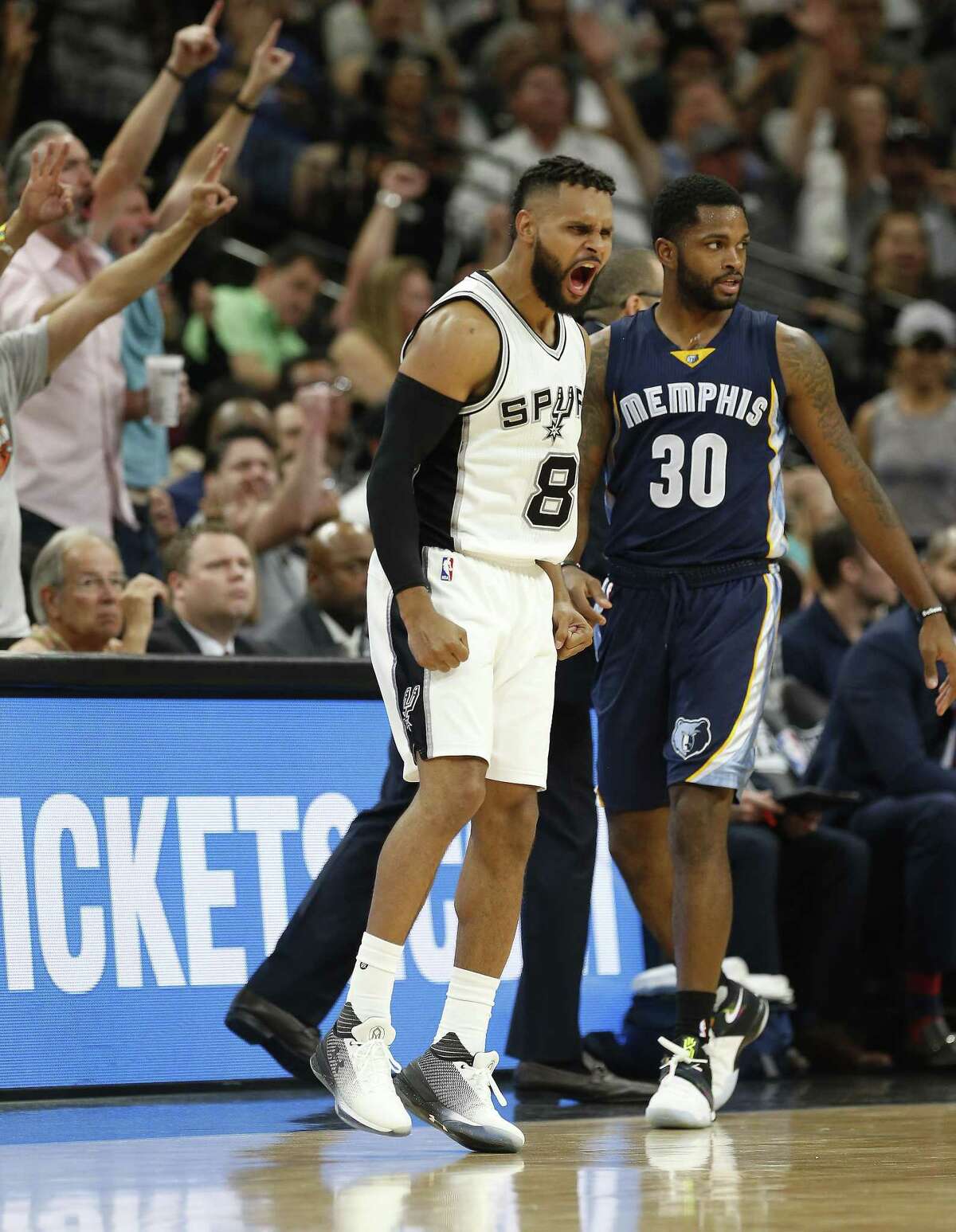Spurs' Patty Mills (08) reacts after sinking a three-pointer against Memphis Grizzlies' Troy Daniels (30) during Game 5 of the Western Conference playoffs at the AT&T Center on Tuesday, Apr. 25, 2017. Spurs take Game 5, 116-103, over the Grizzlies. (Kin Man Hui/San Antonio Express-News)