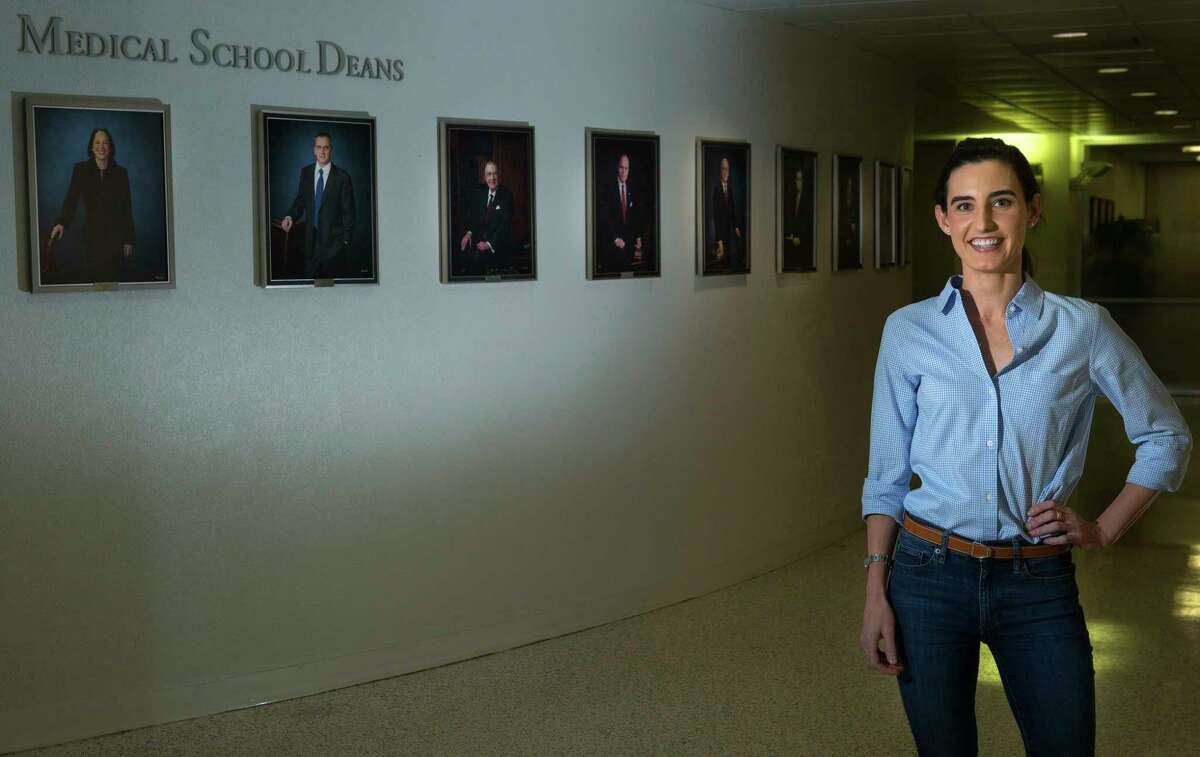 Caroline Hussey, a second-year medical student at UTHealth, recently learned about the huge wage disparity between men and women doctors that can exist. Hussey is standing in front of a wall showing pictures of the McGovern school's deans, who until the most recent dean, were all men, Tuesday, April 24, 2017, in Houston. (Mark Mulligan / Houston Chronicle)
