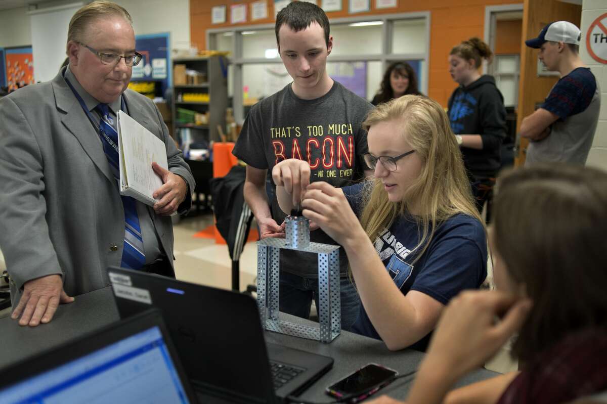 State Superintendent Brian Whiston, left, talks with Meridian Early College High School seniors Josh Bacon, Sarah Jacobs and Katherine Scheibert about what they're doing in their principals of engineering class.