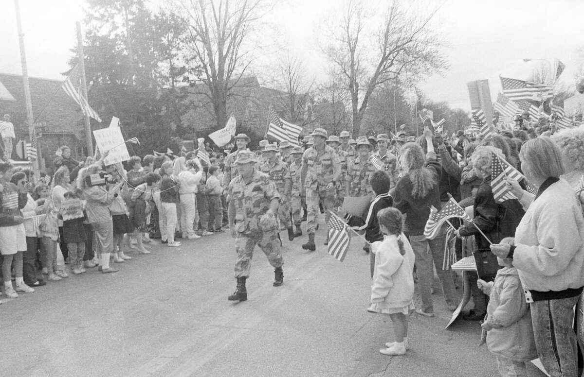 Steve Tracy, director of the Midland County Veterans Service office, leads his platoon as it marches down Main Street. April 1991