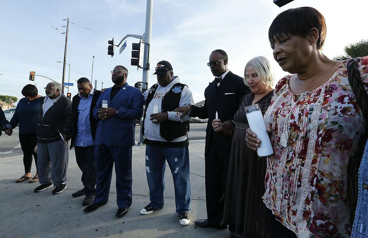 Denise Harlins, right, the aunt of Latasha Harlins, gathers in a prayer circle with South Los Angeles civil rights clergy leaders and members of the community on April 24, 2017 at the intersection of Florence and Normandie in South Los Angeles, to hold a prayer vigil and moment of silence to remember all those who lost their lives nearly 25 years ago in the worst race riot in U.S. history. (Mel Melcon/Los Angeles Times/TNS)