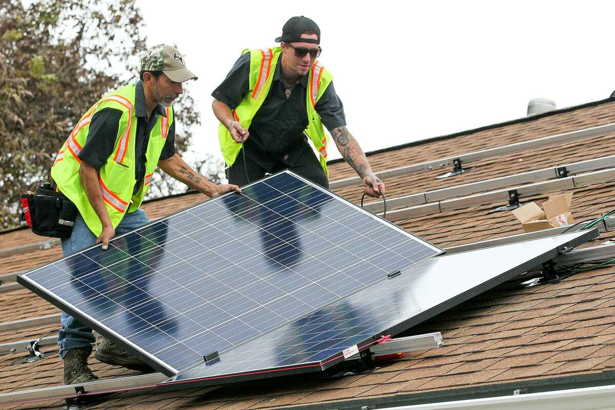 Solar installers place panels on a roof in San Antonio. CPS Energy and local solar companies met Wednesday to discuss new rules that could come into effect as early as June 1.