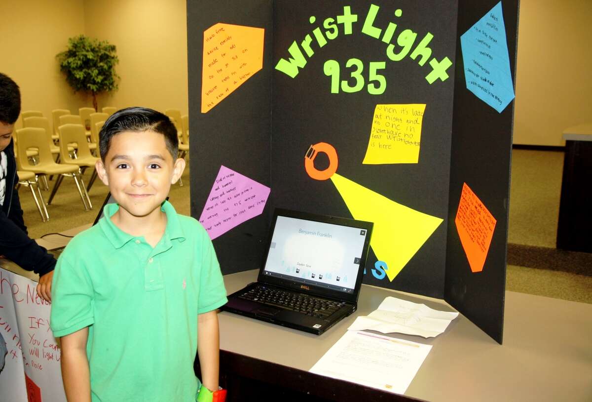 Fourth grade student Zayden Sosa displays his invention, Wristlight 935, during the Innovation Celebration showcase. The invention is a light on a wristband to be worn at night for camping, walking, trips to the bathroom and more.