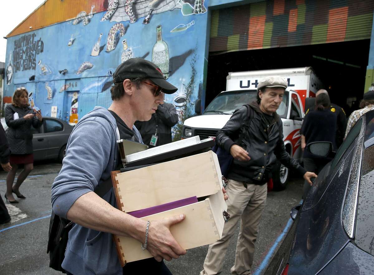 Nathan Cottam loads belongings into his car with the help of Tommi Avicolli Mecca (right), of the Housing Rights Committee of San Francisco, after sheriffs deputies evicted Cottam and other residents of the Bernal Haus artist collective at a warehouse on Peralta Street in San Francisco, Calif. on Wednesday, April 26, 2017.
