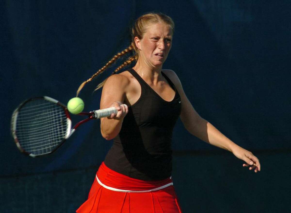New Canaan's Kate Mannelly returns the ball to her opponent, Wilton's Sara Shaughnessy, during CIAC state final action at the Cullman-Heyman Tennis Center at Yale in West Haven, Conn. on Friday June 04, 2010.