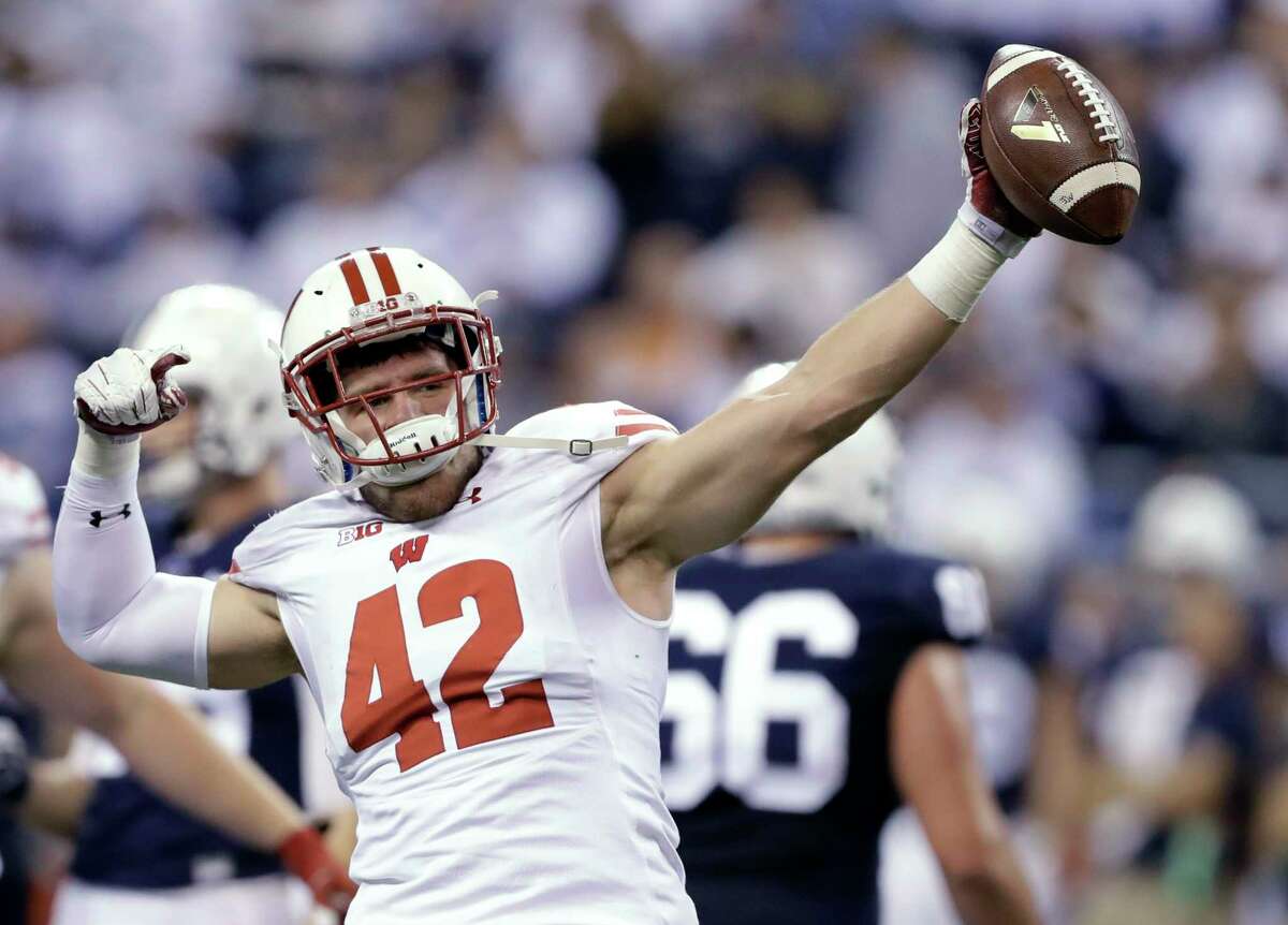 FILE - In this Dec. 3, 2016, file photo, Wisconsin's T.J. Watt celebrates after recovering a fumble during the Big Ten championship NCAA college football game against Penn State in Indianapolis. Watt has a chance to get selected in the first round of the NFL draft on Thursday, just like his brother J.J. in 2011. (AP Photo/Michael Conroy, File)