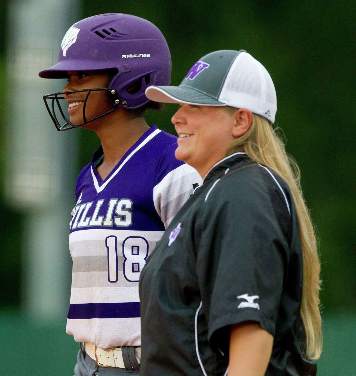 Samara Lagway #18 of Willis shares a laugh with assistant coach Lyndsey Lipscomb after hitting a RBI single during the second inning of a District 20-5A high school softball game, Tuesday, April 25, 2017, in Montgomery.