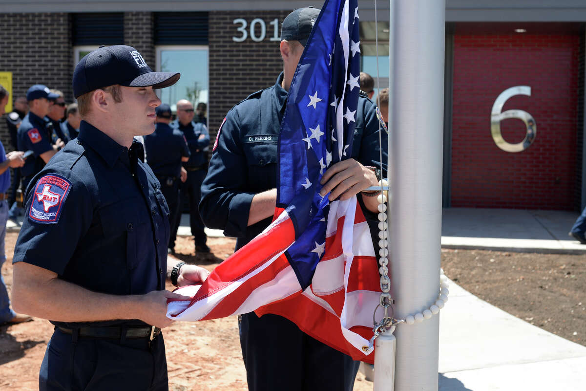 Midland firefighters from left, Dusty Schauer and Clay Perkins hold the US flag during the grand opening ceremony for Fire Station 6 on April 26, 2017. James Durbin/Reporter-Telegram