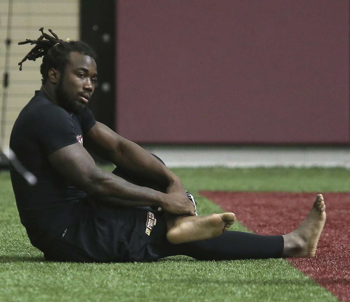 Dalvin Cook stretches prior to running drills for NFL scouts during Florida State's pro day, Tuesday, March 28, 2017 in Tallahassee, Fla. (AP Photo/Steve Cannon)