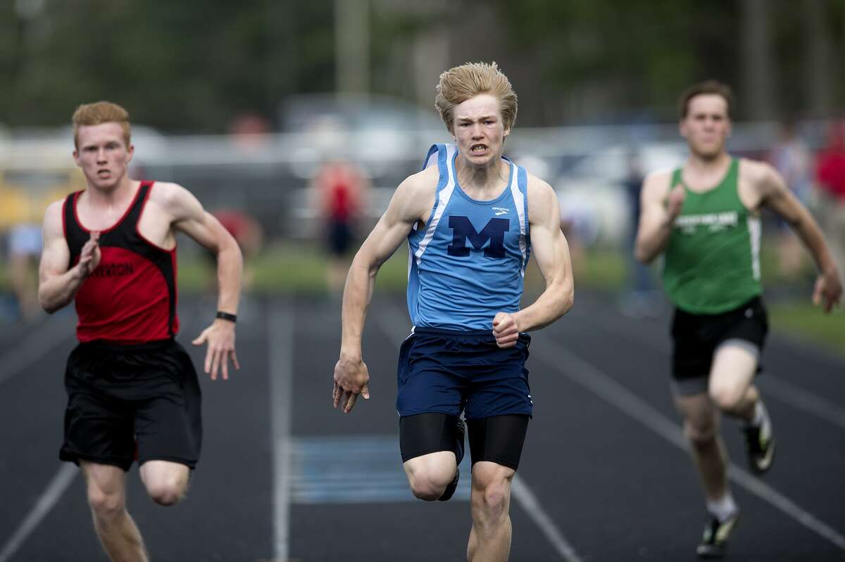Beaverton's David Jenkins, Meridian's Kyle Stockford and Houghton Lake's Austin Land race in the 100 meter dash during a track meet Wednesday afternoon. Stockford won the race.