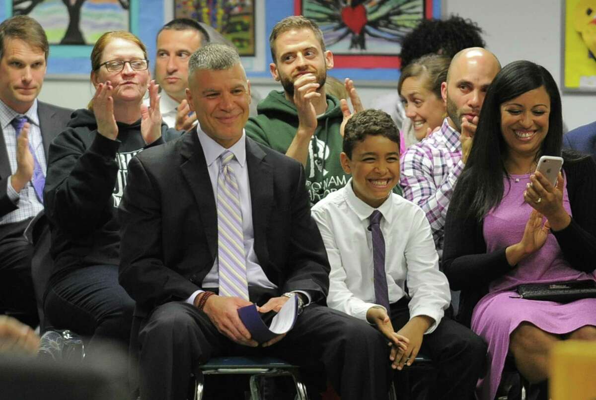 Michael Rinaldi smiles as members of the Stamford Board of Education unanimously approved his appointment as new principal for Westhill High School on Tuesday during its meeting.