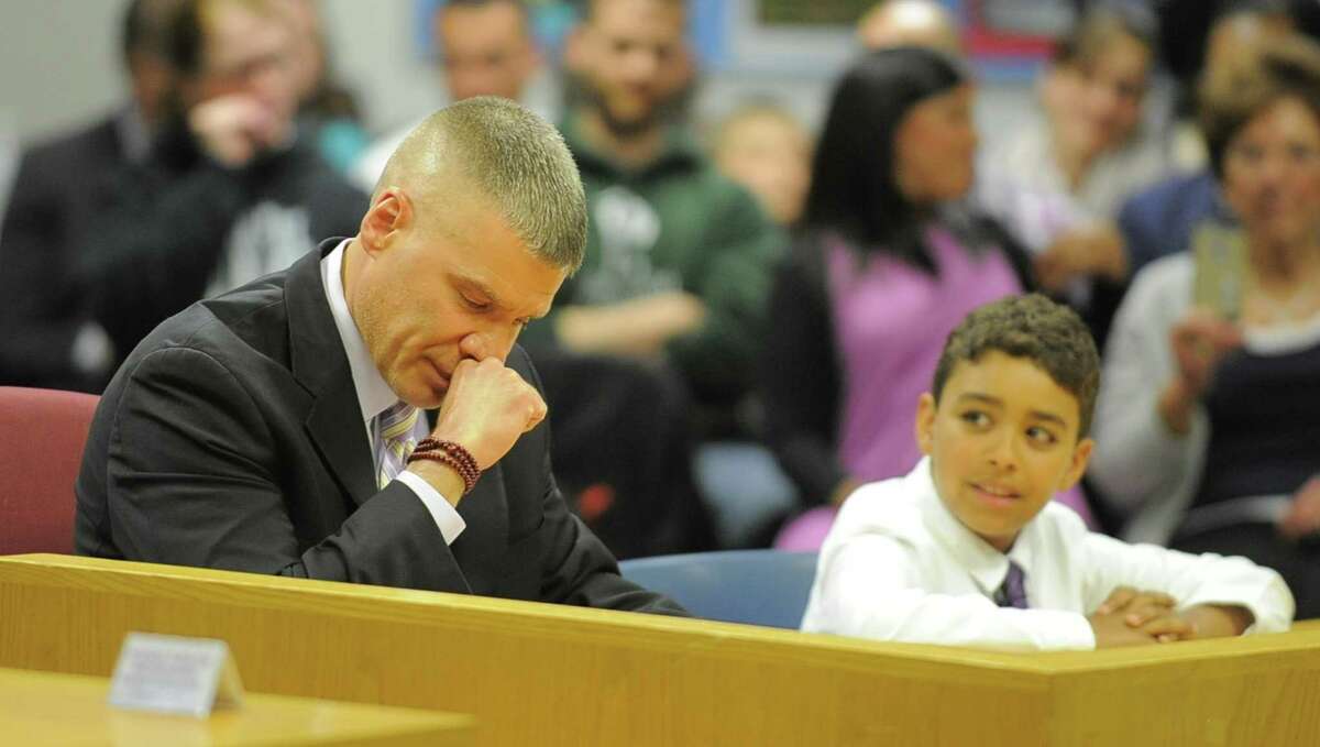 Michael Rinaldi fights back his emotions as he thanks the Stamford Board of Education and Superintendent Earl Kim for unanimously approved his appointment as new principal for Westhill High School on Tuesday, April 25, 2017 during the Stamford Board of Education meeting. Rinaldi, a Stamford native and graduate of Westhill High School, will replace outgoing principal Camille Figluizzi, who is retiring. At right is his son Nikolas who helped his father conclude his remarks by shouting "Westhill and Proud".