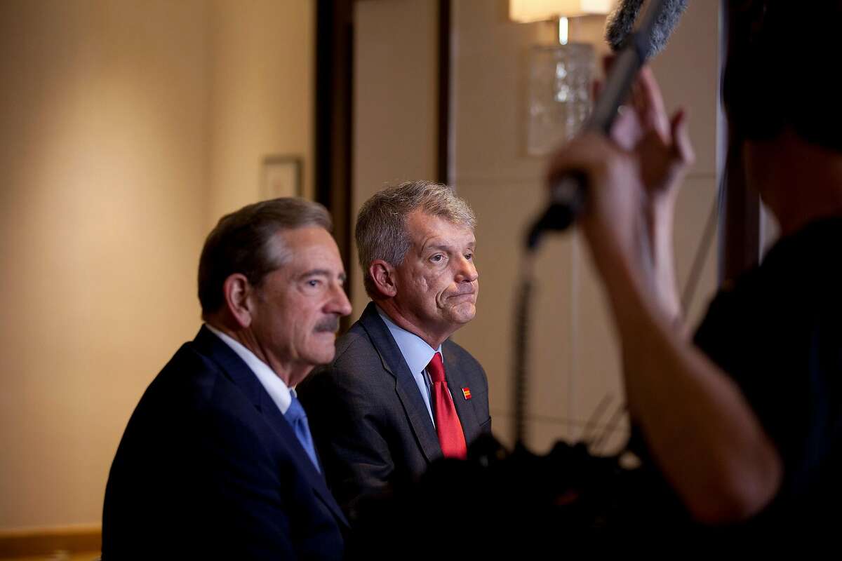 Stephen Sanger, chairman of Wells Fargo, left, and Tim Sloan, chief executive of the bank, talk with reporters after a shareholders meeting in Ponte Vedra Beach, Fla., April 25, 2017. Despite the turmoil that has engulfed Wells Fargo in the past year, shareholders voted Tuesday to re-elect all of the bank�s 15 directors. But some of the board members edged in just barely. (Charlotte Kesl/The New York Times)