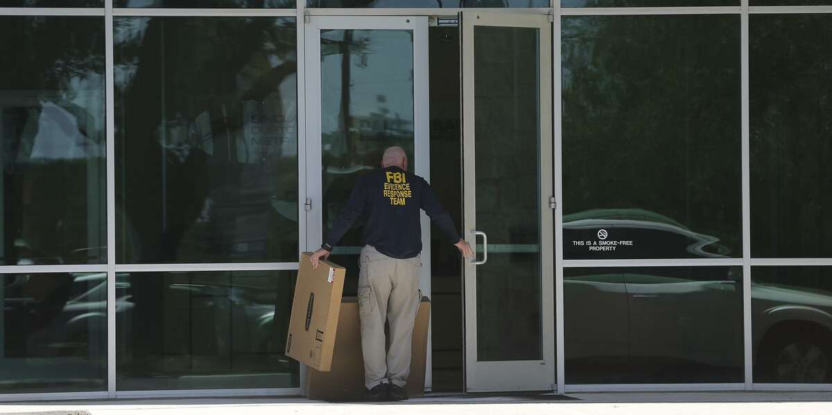 A man wearing a shirt that reads "FBI Evidence Response Team" walks Wednesday April 26, 2017 into the building located at 415 Embassy Oaks in San Antonio. A placard in front of the building was identified with the word "Dannenbaum." According to the Laredo Morning Times website, the FBI has raided some city and county buildings in Laredo as well as Dannenbaum Engineering.