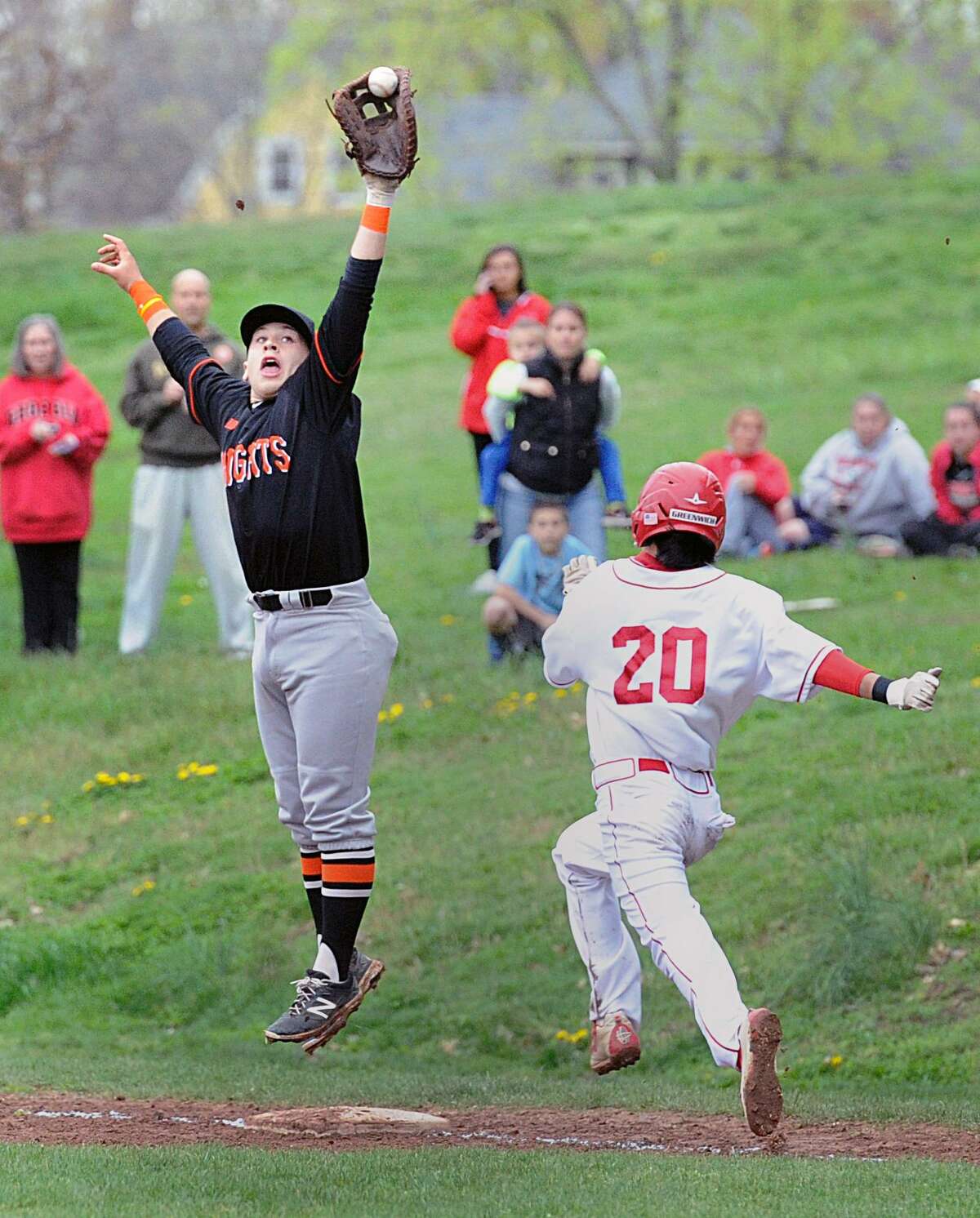 Greenwich’s Mark Sunoo beats out a bunt as Stamford first baseman Justin Wexler is pulled off the bag on a high throw in the second inning of the Cardinals’ 7-2 victory on Wednesday in Greenwich.