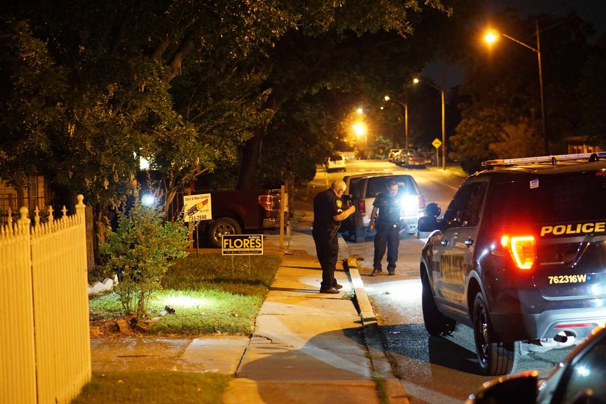 San Antonio Police Department investigators look for shotgun shell casings Wednesday night, April 26, in the 1600 block of West Olmos Drive. A resident fired three shots at a driver who threatened him with a gun, police said. 