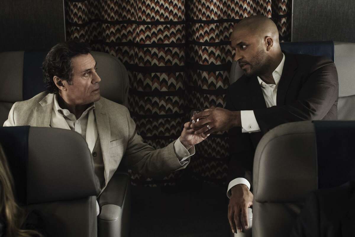Ian McShane, left, and Ricky Whittle meet on a plane in an early scene from, ‘American Gods’ on Starz.