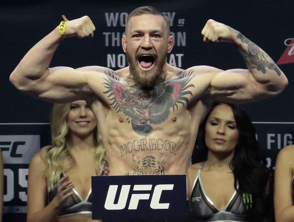 Conor McGregor stands on a scale during the weigh-in event for his fight against Eddie Alvarez in UFC 205 mixed martial arts on Nov. 11, 2016, at Madison Square Garden in New York.