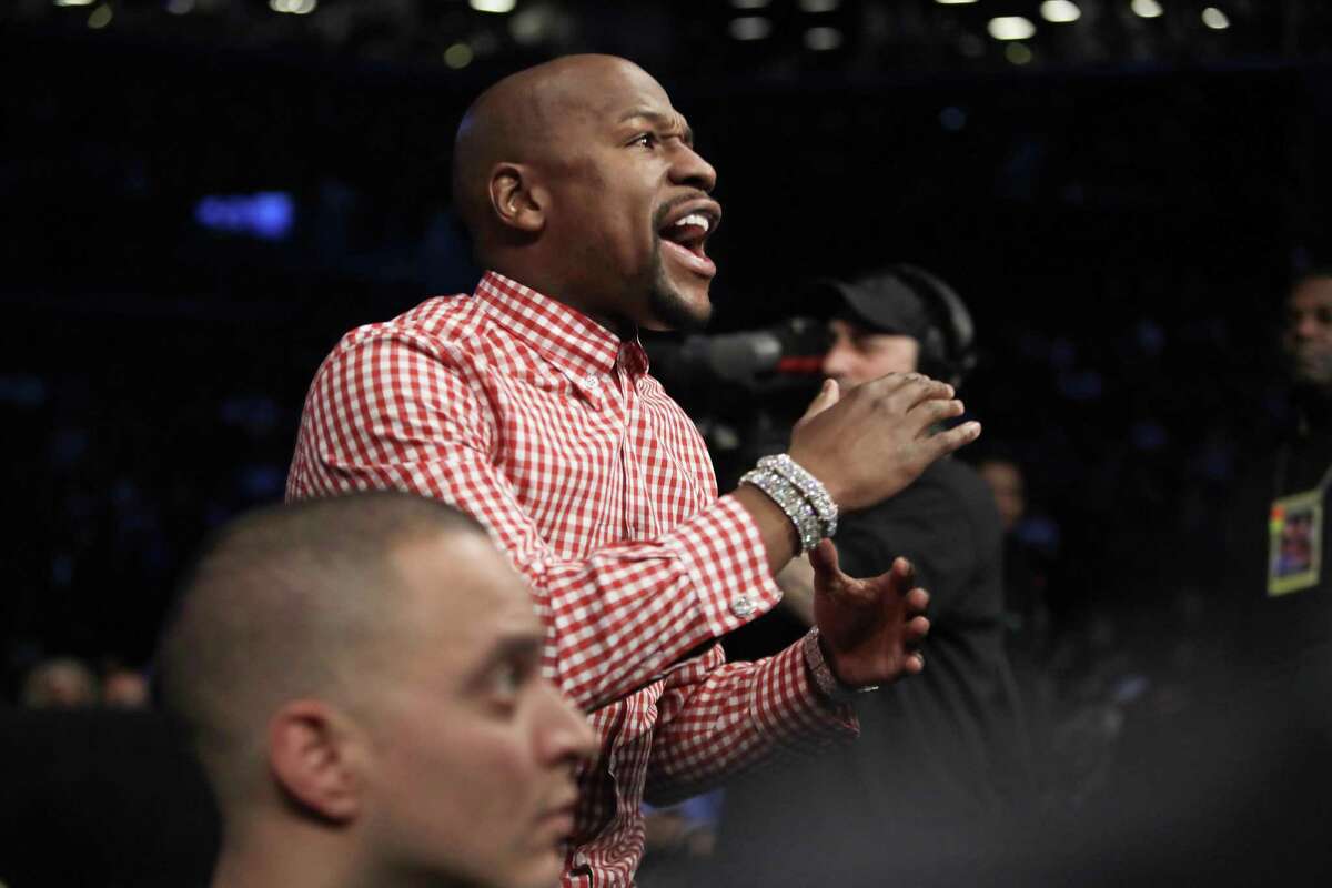 Boxer Floyd Mayweather Jr. reacts during the third round of a junior lightweight title fight between Jose Pedraza and Gervonta Davis in New York on Jan. 14, 2017. Mayweather says facing UFC star Conor McGregor in a boxing ring “can happen” and is something that would “give the fans what they want to see.”