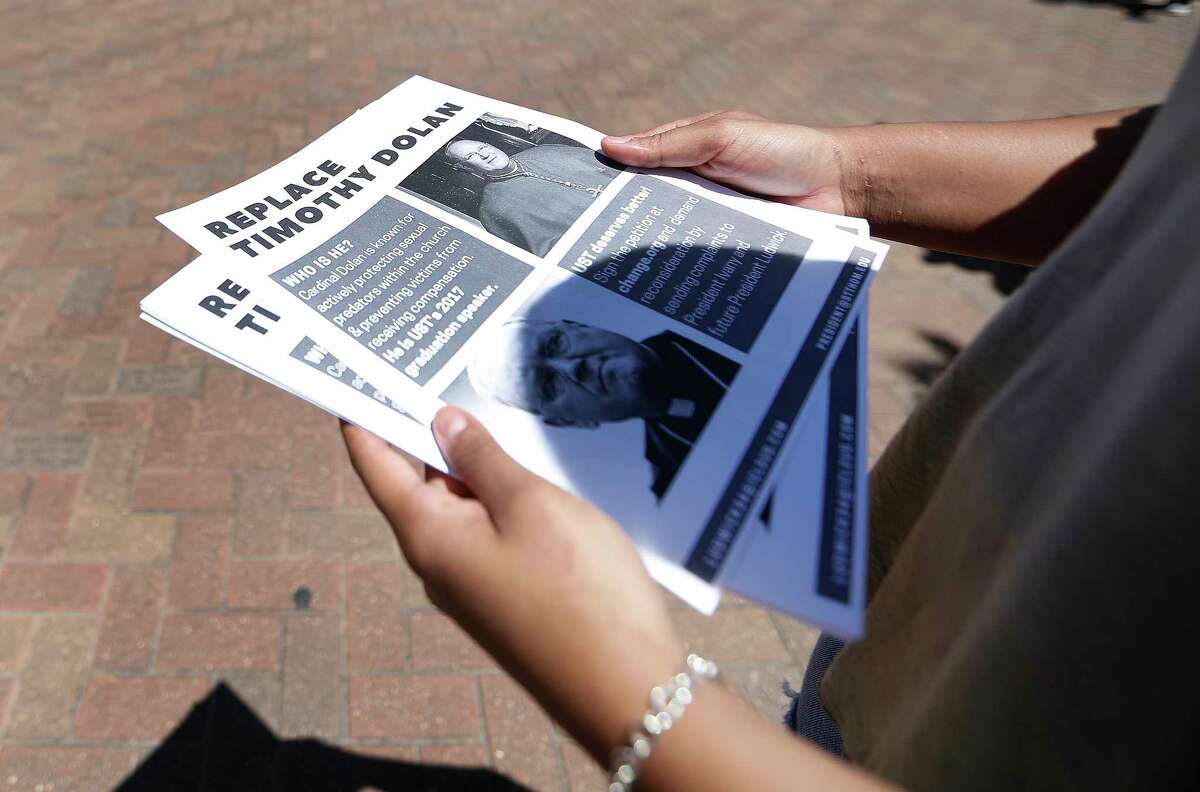 ﻿New York City archbishop Timothy Dolan's commencement speech is being challenged by University of St. Thomas students like Taylor Forrest who passed out fliers with coverage of allegations against him.