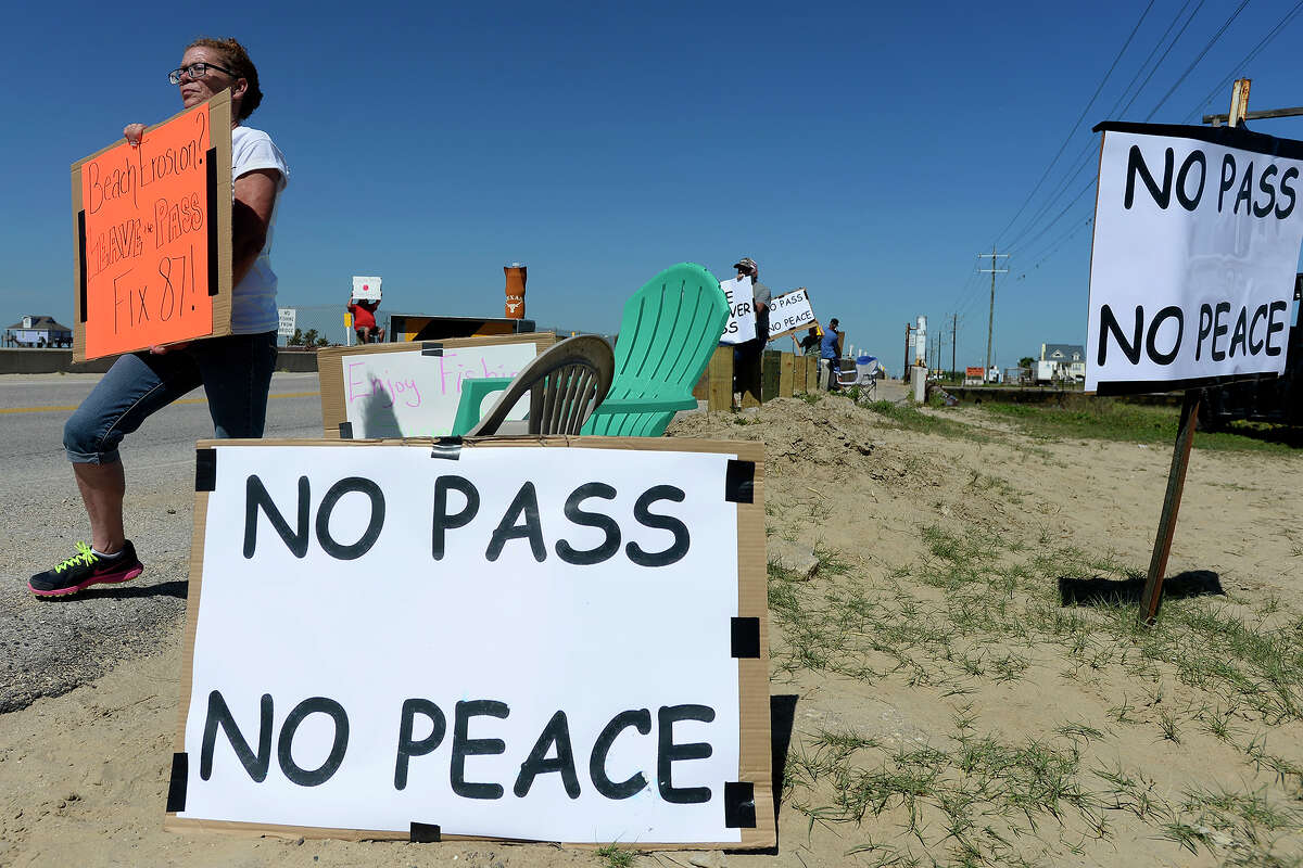Buffy Dievel, of High Island, holds a protest sign at Rollover Pass on the Bolivar Peninsula on Monday afternoon. Photo taken Monday 4/24/17 Ryan Pelham/The Enterprise
