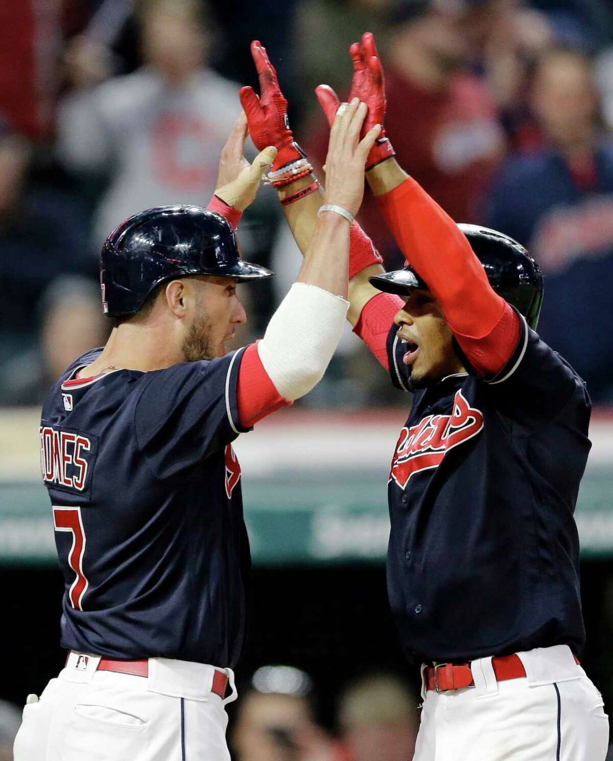 Cleveland Indians' Francisco Lindor, right, is congratulated by Yan Gomes after the scored on Lindor's two-run home run off Houston Astros relief pitcher Chris Devenski during the seventh inning of a baseball game, Thursday, April 27, 2017, in Cleveland. (AP Photo/Tony Dejak)