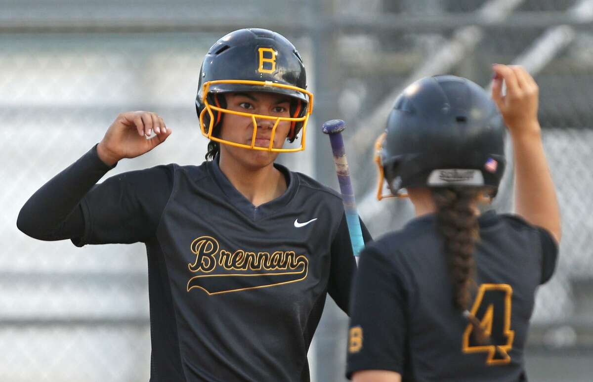 Brennan’s Alexia Camacho (left) celebrates with teammate Christina Michel after scoring a run in Game 1 of the Class 6A bidistrict playoff series against Smithson Valley on April 27,2017