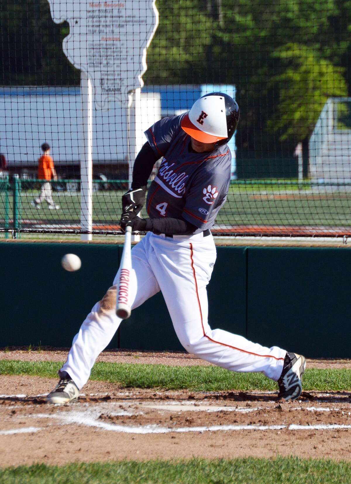 Edwardsville’s Dylan Burris singles up the middle in the fourth inning for his third hit of the game.