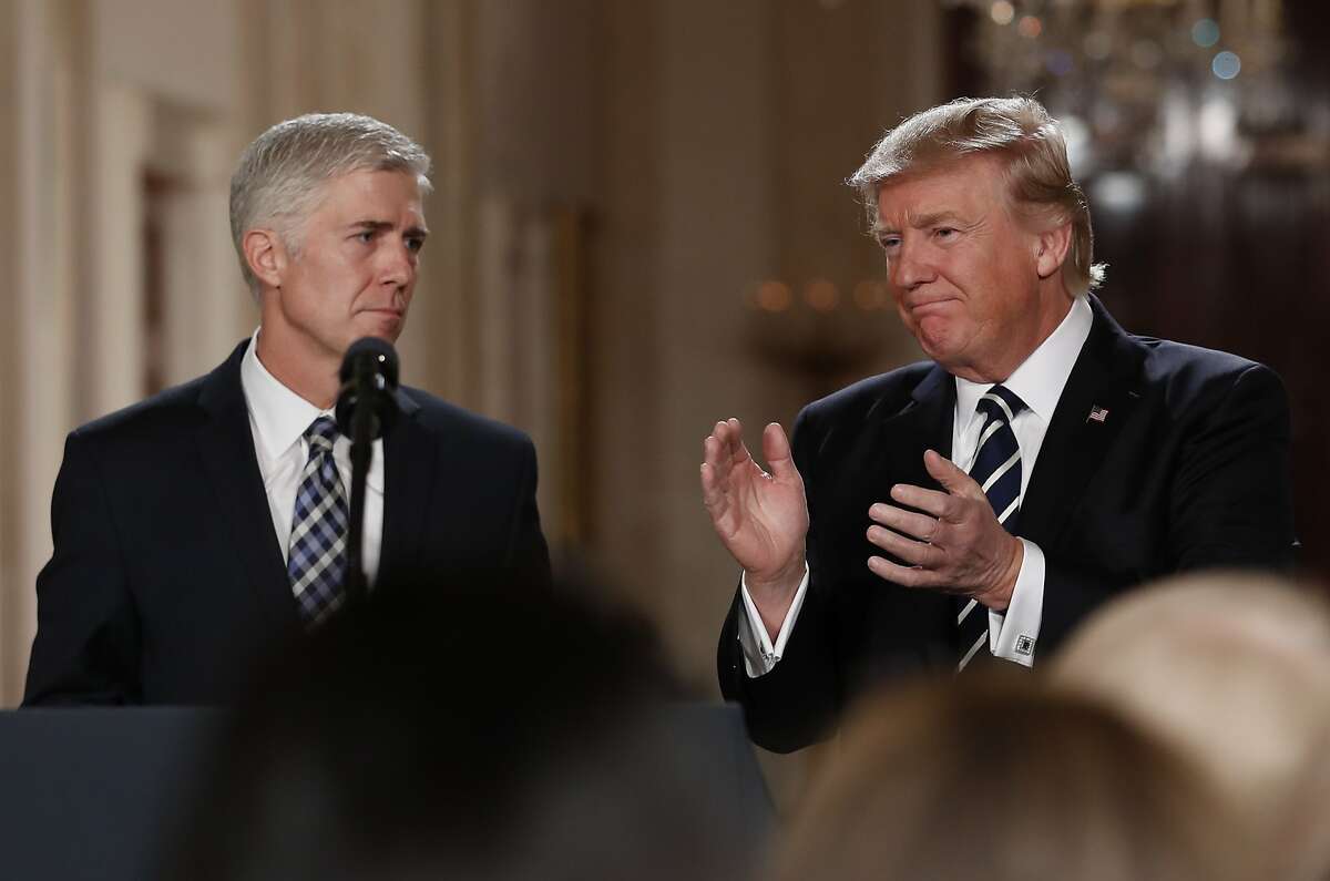 President Donald Trump applauds as he stands with Judge Neil Gorsuch in East Room of the White House in Washington, Tuesday, Jan. 31, 2017, after announcing Gorsuch as his nominee for the Supreme Court. (AP Photo/Carolyn Kaster)
